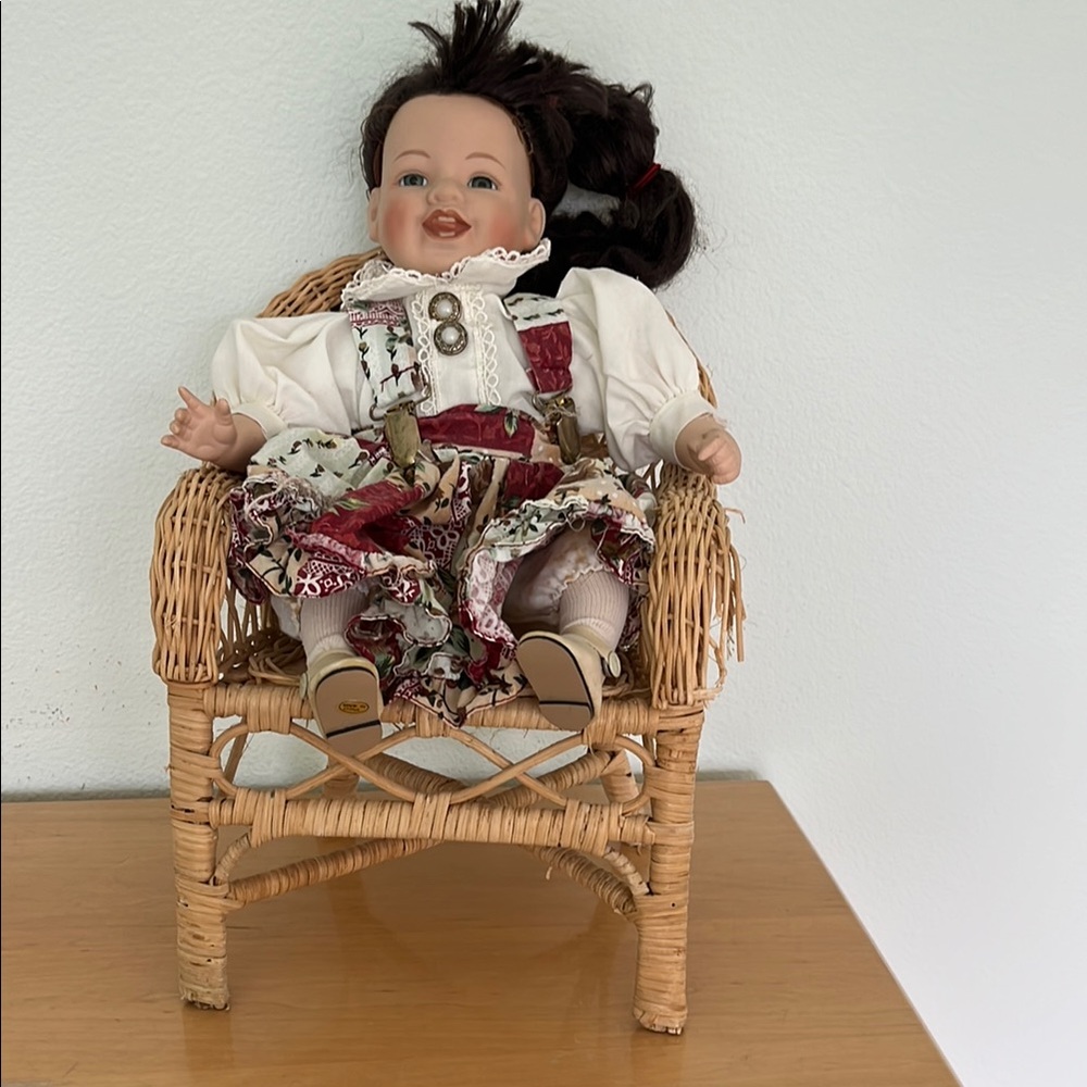 Porcelain doll in red and white outfit.